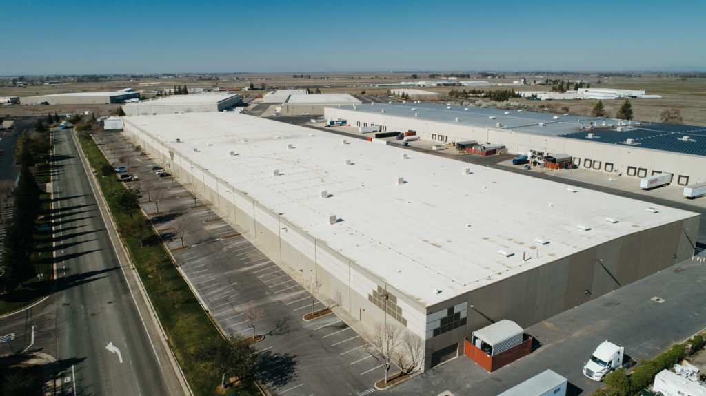 Shows the flat, rectangular shape of commercial roofs.