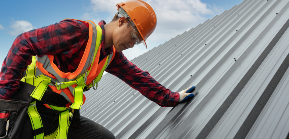Image of a commercial roofer inspecting a commercial roof.
