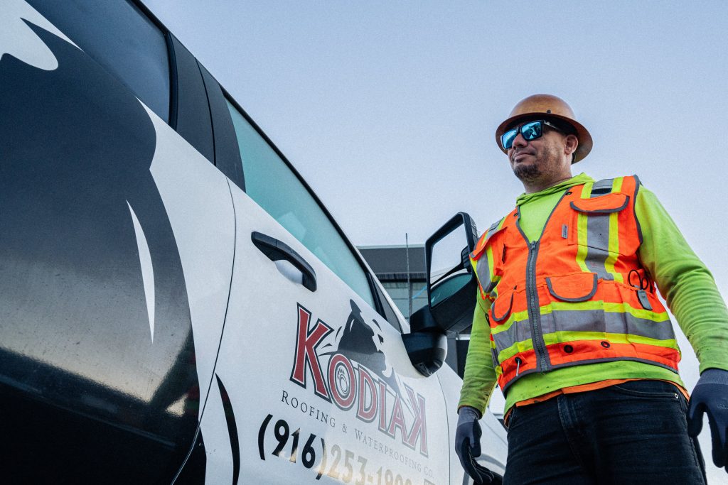 Kodiak worker standing by work truck