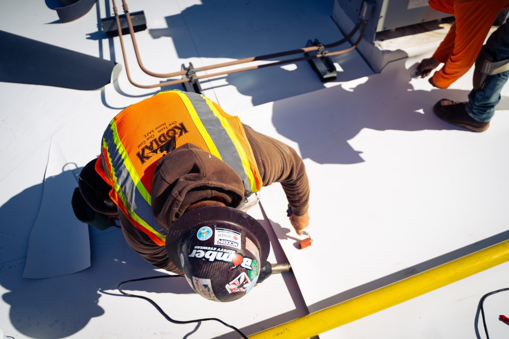 Close up view of Kodiak worker on roof