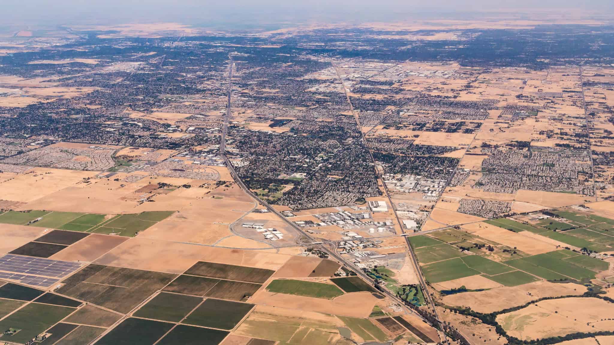 An expansive aerial view of Elk Grove, California, showcasing a mix of farmland and urban development. This image highlights the growing community that relies on Kodiak Roofing

Elk Grove, California, commercial roofing, roofing services, waterproofing, solar installation, Kodiak Roofing, aerial view, farmland, urban development, roofing maintenance, re-roofing, emergency roof repair, sustainable roofing, energy efficiency, metal roofing, property protection, California roofing contractor, Elk Grove community.