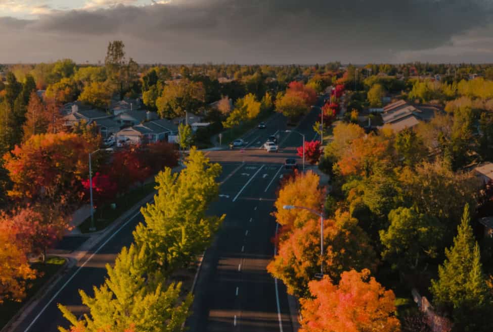 A vibrant aerial view of Galt, California, during autumn, showcasing colorful trees lining the streets of a residential area. This image highlights the community that benefits from Kodiak Roofing Galt, California, commercial roofing, roofing services, waterproofing, solar installation, Kodiak Roofing, aerial view, fall colors, residential community, roofing maintenance, re-roofing, emergency roof repair, sustainable roofing, energy efficiency, metal roofing, property protection, California roofing contractor.